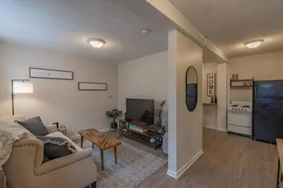 a living room with a couch and a tv at University Suite 