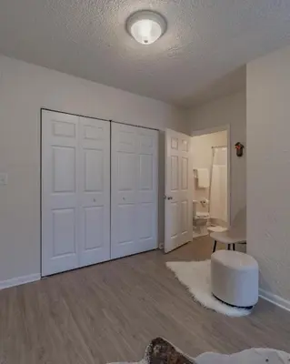 a living room with white walls and white doors at University Suite 