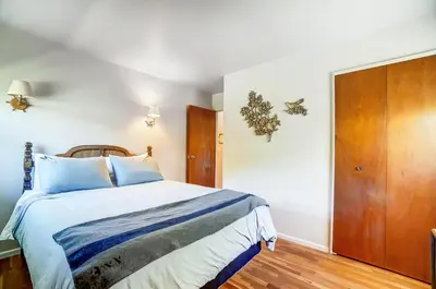 a bedroom with a bed and a wooden door at Retro Refuge On Woodstock Dr in Van Wert