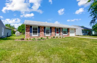 a home with a brick house with a yard at Retro Refuge On Woodstock Dr in Van Wert