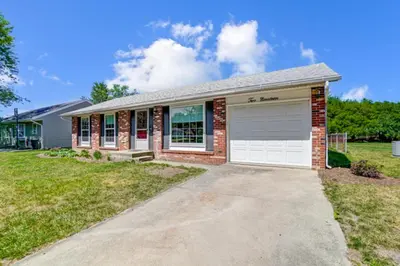 a brick house with a garage at Retro Refuge On Woodstock Dr in Van Wert