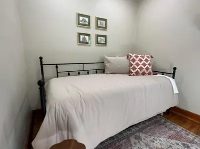 a bedroom with a bed with white sheets and pillows at Vintage Charm on Elson Ave in Van Wert