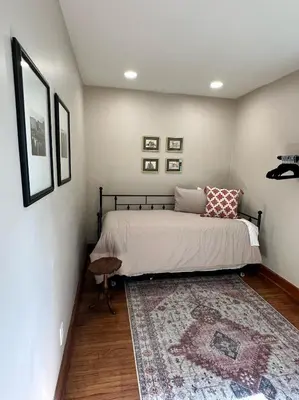 a bedroom with a bed and a rug on a floor at Vintage Charm on Elson Ave in Van Wert