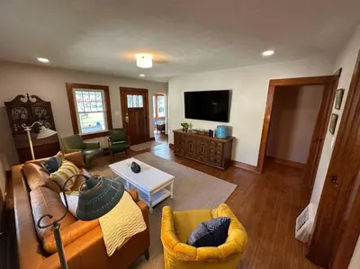 a living room with couches and a tv at Vintage Charm on Elson Ave in Van Wert