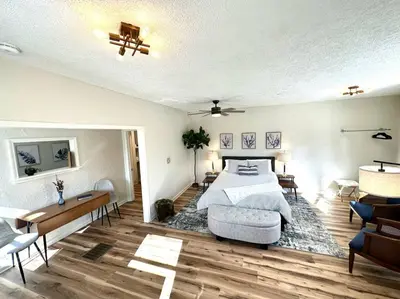 a bedroom with a bed and a table and chairs at University Suite 