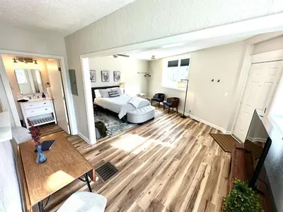 a living room with a bed and a table at University Suite 