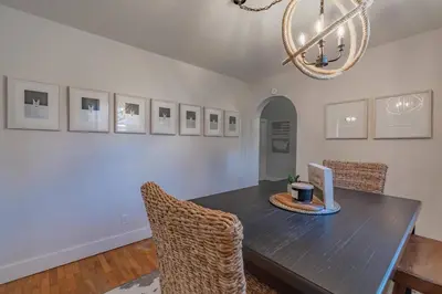 a dining room with a table with chairs and a laptop at Lodge On Landess in Marion