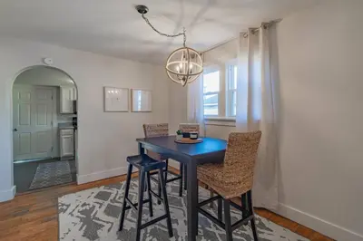 a dining room with a blue table and chairs at Lodge On Landess in Marion