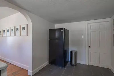 a black refrigerator in a room with a door at Lodge On Landess in Marion