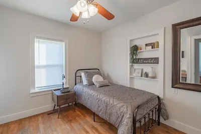 a bedroom with a bed and a ceiling fan at Lodge On Landess in Marion