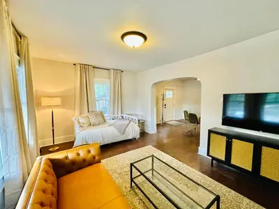 a living room with a couch and a television at Campus Haven in Kiley