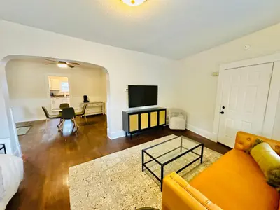 a living room with a couch and a tv at Campus Haven in Kiley