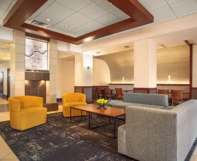 a lobby with couches and chairs and a table at Hyatt Place Cincinnati Blue Ash in Blue Ash