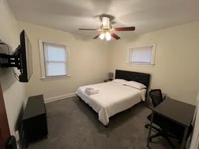 a bedroom with a bed and a ceiling fan at StayWithJay Premium Furnished Room near Cleveland Airport in Cleveland