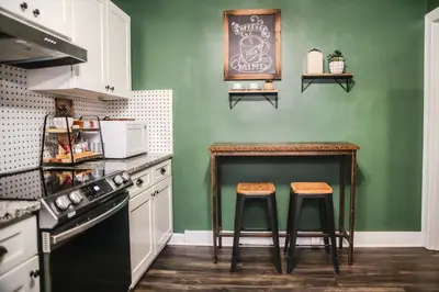 a kitchen with a table and two stools at Fauver Suite in Dayton