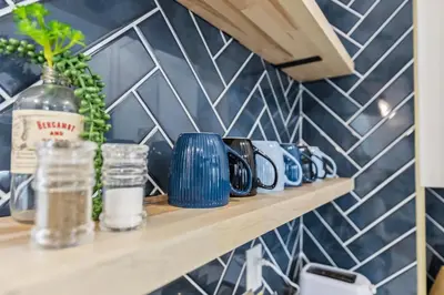 a shelf in a kitchen with blue and white tiles at Charming 3BR Home - Close to CLE Clinic in Cleveland Heights