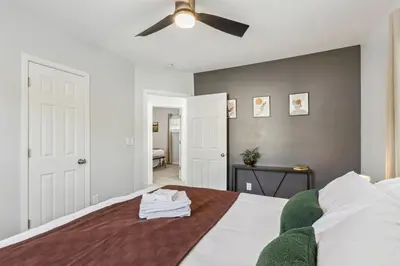 a bedroom with a bed with a ceiling fan at Charming 3BR Home - Close to CLE Clinic in Cleveland Heights