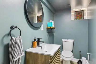 a bathroom with a white sink and a mirror at Charming 3BR Home - Close to CLE Clinic in Cleveland Heights