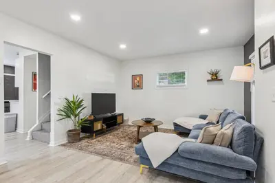 a living room with a blue couch and a tv at Charming 3BR Home - Close to CLE Clinic in Cleveland Heights