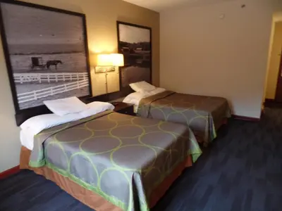 a hotel room with two beds and a window at Super 8 by Wyndham Beaver Falls in Beaver Falls