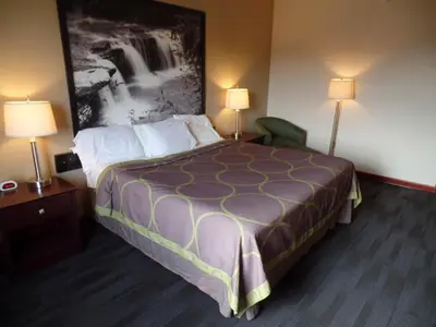 a hotel room with a bed and two lamps at Super 8 by Wyndham Beaver Falls in Beaver Falls