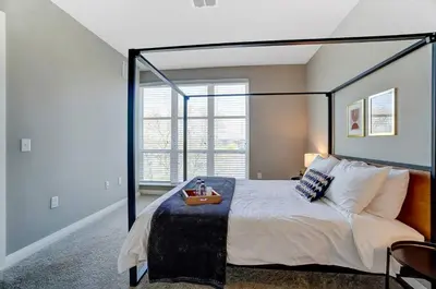 a bedroom with a large bed with a large window at The Urban Oasis Garage Parking Walk-In Shower in Columbus
