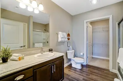 a bathroom with a sink and a toilet and a mirror at The Urban Oasis Garage Parking Walk-In Shower in Columbus
