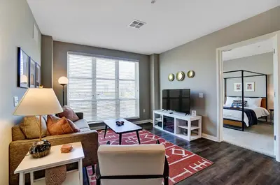 a living room with a couch and a room with a bed at The Urban Oasis Garage Parking Walk-In Shower in Columbus
