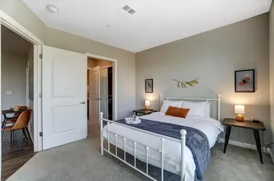 a bedroom with a white bed and a table at The Urban Oasis Garage Parking Walk-In Shower in Columbus