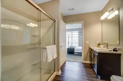 a bathroom with a glass shower and a sink at The Urban Oasis Garage Parking Walk-In Shower in Columbus