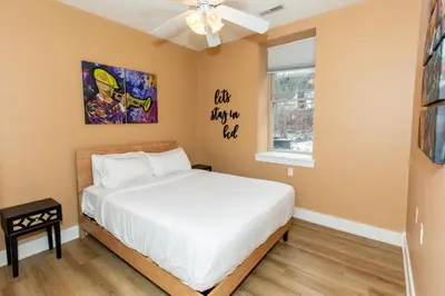 a bedroom with a bed and a window at The Jazz Club Downtown Sandusky in Sandusky