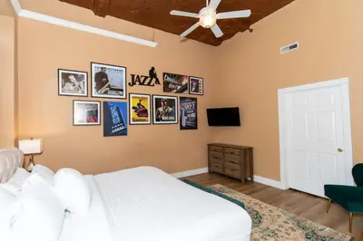 a bedroom with a bed and pictures on the wall at The Jazz Club Downtown Sandusky in Sandusky