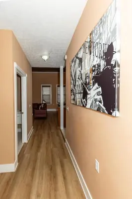 a living room with a large painting on the wall at The Jazz Club Downtown Sandusky in Sandusky