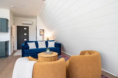 a living room with a blue couch and two chairs at Cherry Hollow in McArthur