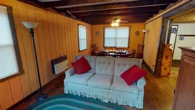 a living room with a couch with two red pillows at East Fork Acres in Logan