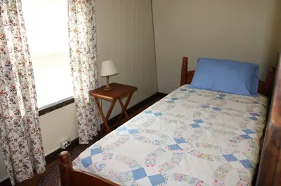 a bedroom with a bed and a window at East Fork Acres in Logan