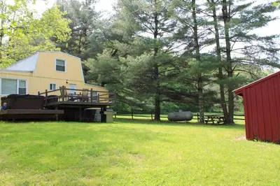 a large yard with a house and a red shed at East Fork Acres in Logan