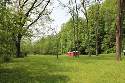 a park with a red tent in the middle of a field at East Fork Acres in Logan
