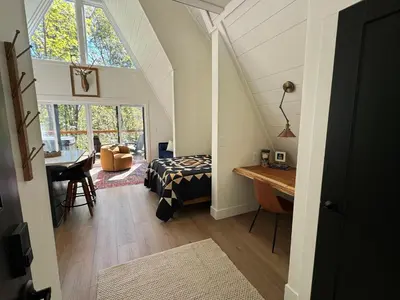 a bedroom with a bed and a desk in a room at Hickory Hollow in McArthur