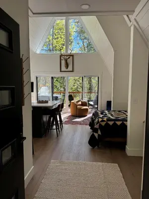 a room with a bed and a table and a window at Hickory Hollow in McArthur