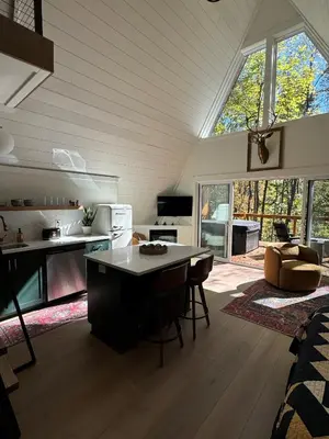 a kitchen and living room with a table and chairs at Hickory Hollow in McArthur