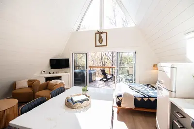 a kitchen and living room with a vaulted ceiling at Oak Hollow in McArthur