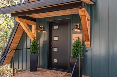 a front door of a house with a green wall at Oak Hollow in McArthur