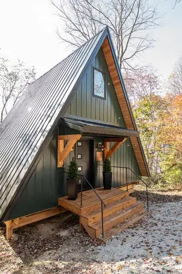 a green building with a staircase in front of it at Oak Hollow in McArthur