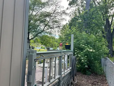 a porch with a fence and flowers on it at Winifreds Hideaway in Berea