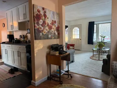 a kitchen and a living room with a table at Winifreds Hideaway in Berea