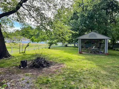 a gazebo in a field with a tree at Winifreds Hideaway in Berea