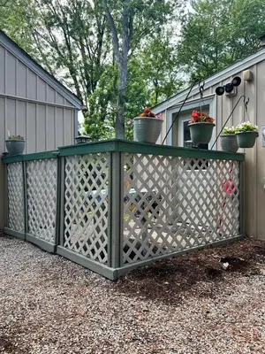 a green fence with potted plants on top of it at Winifreds Hideaway in Berea