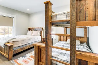 a room with two bunk beds and a window at Family Retreat with Fire Pit and Yard in Mineral City in Mineral City