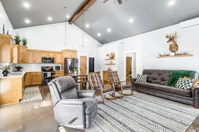 a living room with a couch and chairs and a kitchen at Family Retreat with Fire Pit and Yard in Mineral City in Mineral City